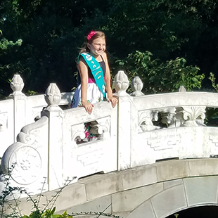 Girl Scout standing on bridge in the Chinese Garden
